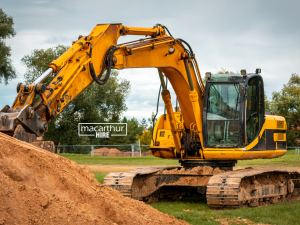 Excavator digging bucket and grading bucket attachments displayed beside compact earthmoving equipment
