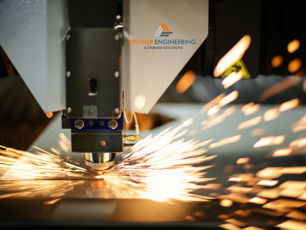 CO2 laser cutting machine producing detailed shapes in a clear acrylic sheet.