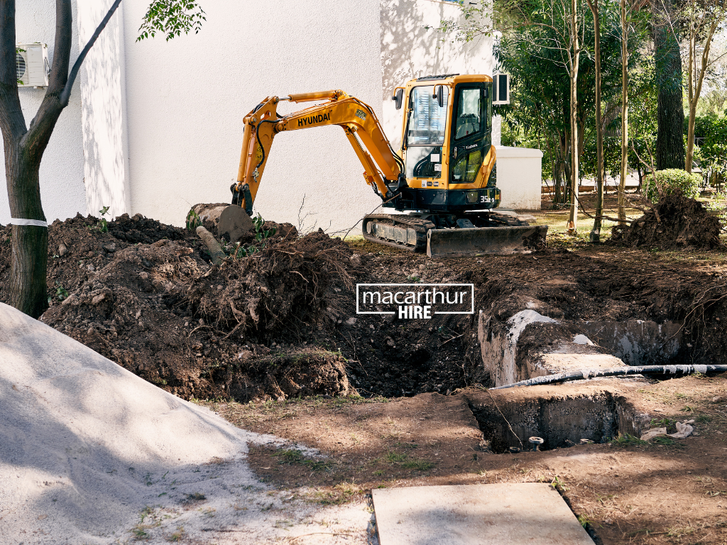 Garden cultivator preparing soil for new garden beds in a residential backyard