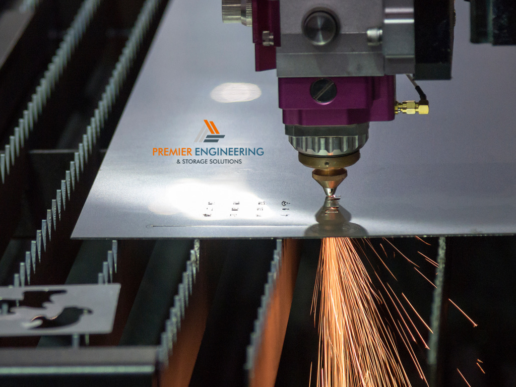 Fabrication engineer discussing sheet metal components, technical drawings and manufacturing requirements with a customer.