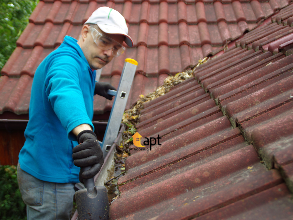 Roofing tradesperson repairing guttering on a residential roof to improve rainwater drainage. residential roof repair sydney roof leak repair cost, tile roof repair sydney, emergency roof repair sydney, roof repairs sydney, roof refurbishing sydney, storm damage roof repair, emergency ceiling leak repair