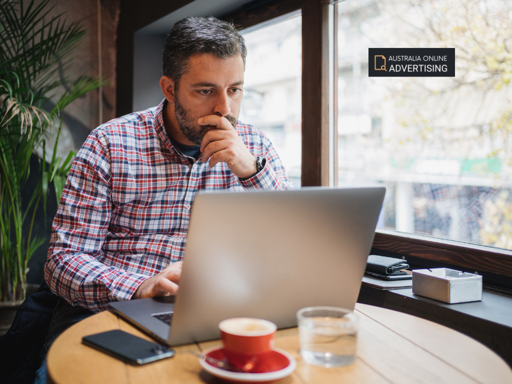 Small business owner reviewing online advertising clicks and enquiry conversions on a laptop dashboard. Online advertising australia, ads online, advertising online, advertise online, internet advertising, internet advertising services, online advertising companies